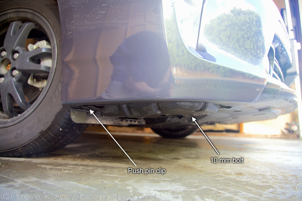 Remove push-pin clip and 10 mm bolt from underneath side of front bumper