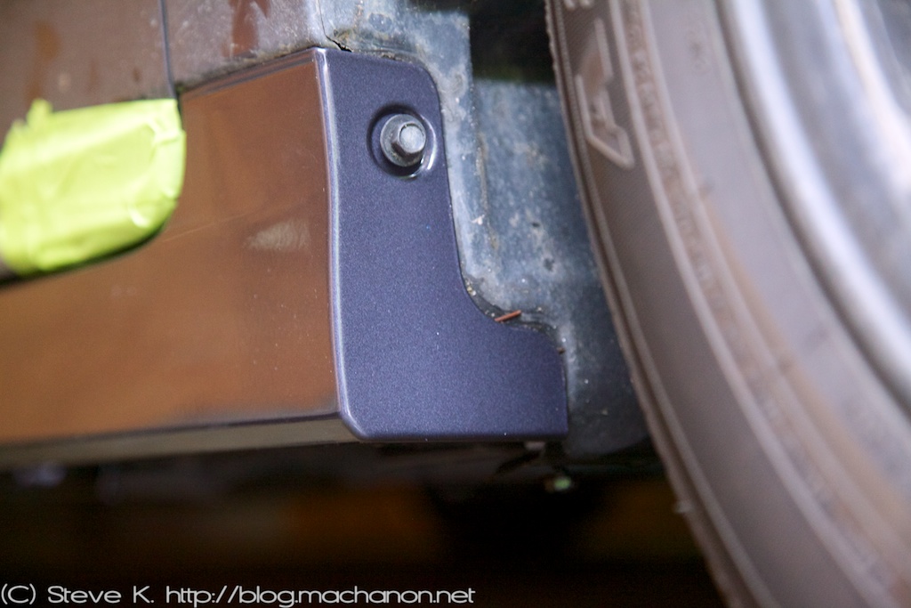 Replace the two 10 mm bolts that were removed from the front of the OEM side rocker earlier