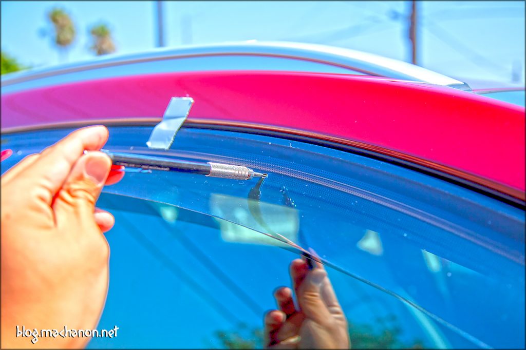 Mark the rubber door frame weather stripping by inserting a pencil through each of the three holes on the visor.
